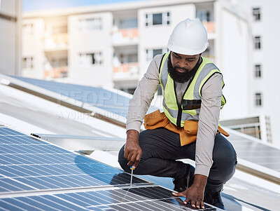 Buy stock photo African engineer man, screwdriver and solar panel on roof for maintenance, industry or thinking in city. Technician, builder and tools for photovoltaic tech, helmet and sustainable renewable energy