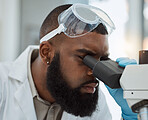 Science, microscope and a man in a laboratory for medical research, study or analysis. Face of a black male person or scientist with a scope for innovation, biotechnology and future development