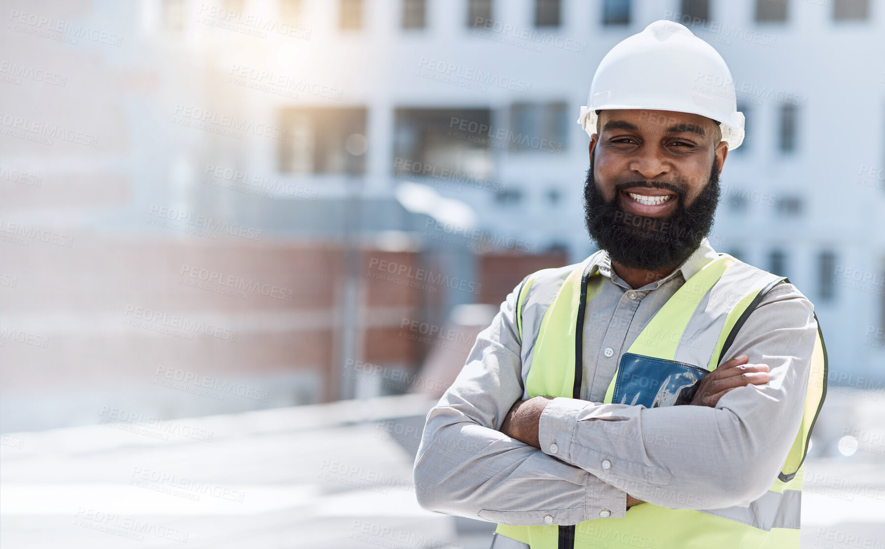 Buy stock photo Man, engineering portrait and arms crossed at city construction site, solar panels and rooftop design technician. Happy face of african person, architecture, worker or contractor in outdoor mockup