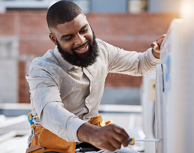 Buy stock photo Building, engineer and air conditioner install with a black man on a roof for construction or manual labor. Industrial, engineering and an electrician working on ac repair for maintenance or service