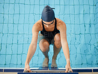 Swimming, start and top view of woman in pool for exercise, training and workout for competition in gym. Fitness, water sports and female swimmer on starting block for race, challenge and performance