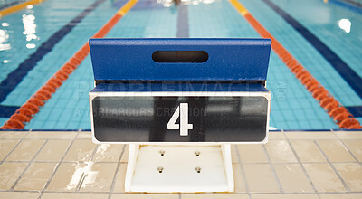 Empty swimming pool, platform and start competition of water sports, race and contest at diving facility. Background of number on jump block at poolside arena to begin exercise, training and fitness