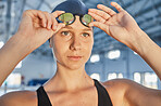 Fitness, thinking and goggles with a woman swimmer getting ready for an event, race or competition in a gym. Sports, exercise and workout with a young female athlete training at a swimming pool