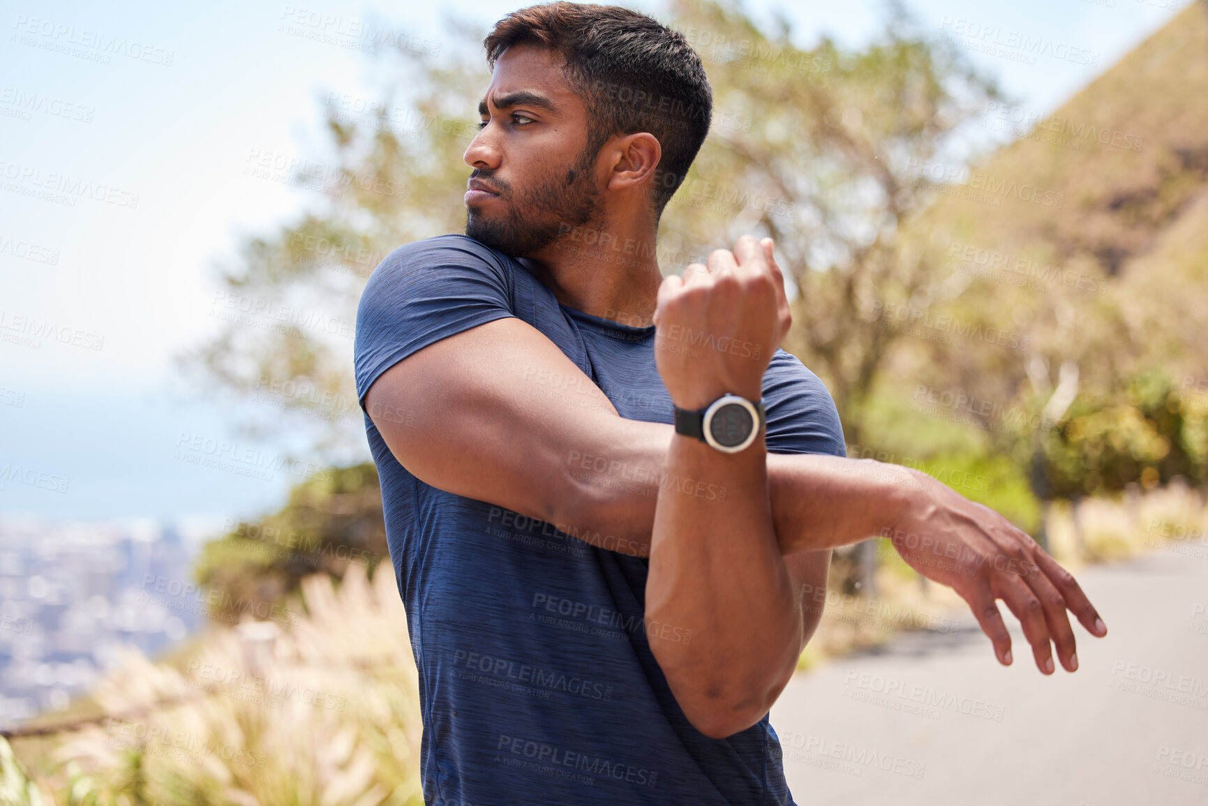 Buy stock photo Thinking, man or runner stretching arms for fitness training, wellness or exercise outdoors on road. Relax, muscle flexibility and healthy Indian male athlete in warm up to start running workout