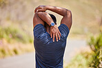 Fitness, man or runner stretching arms for fitness training, wellness or cardio exercise outdoors on road. Relax, flexibility and back view of healthy male athlete in warm up to start running workout