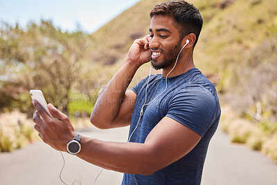 Buy stock photo Fitness, happy man or runner with music on mobile app online in training, workout or exercise on road. Headphones, radio audio or healthy athlete listening or streaming podcast to start running 