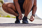 Running, hands or person on road with shoes for fitness exercise, workout and marathon training. Closeup, tying lace or athlete runner ready to run, walk or jog with sneakers, trainers or footwear  