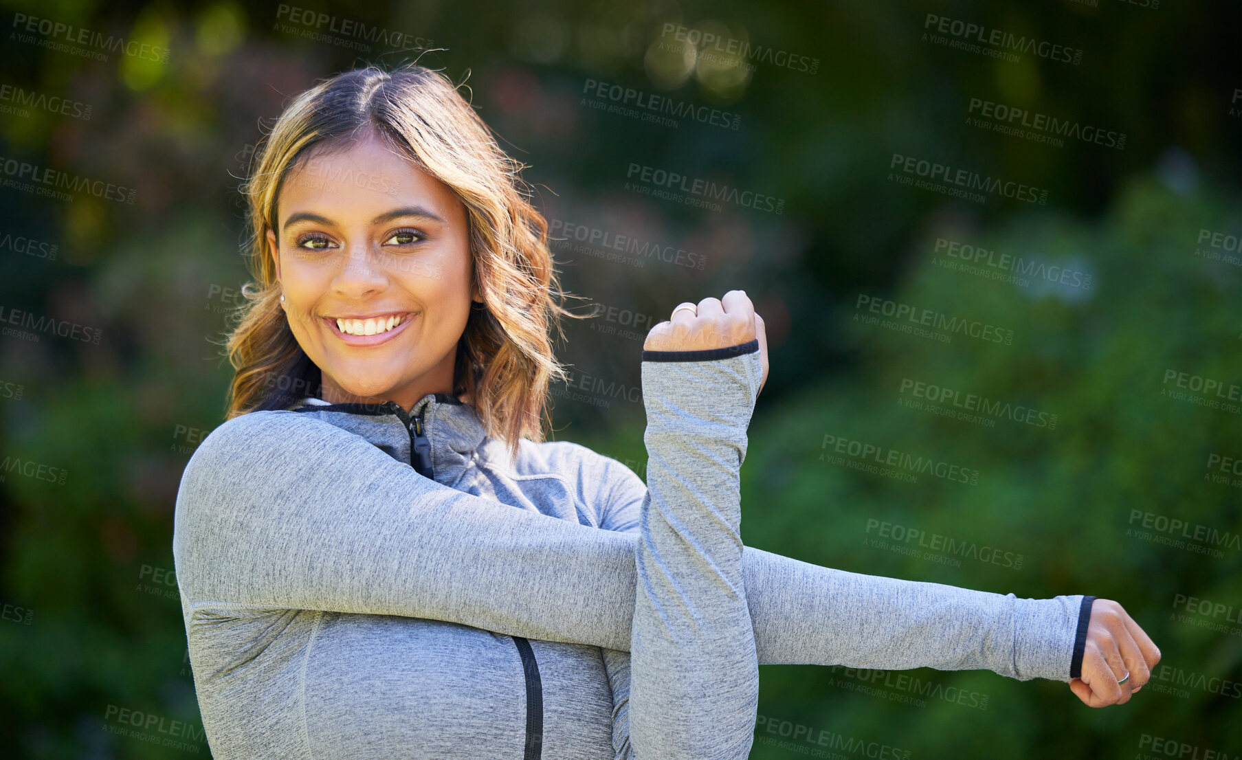 Buy stock photo Nature, sports and portrait of a woman stretching her arms for an outdoor workout or training. Fitness, happy and young female athlete doing a warm up exercise in a park for cardio running in garden.