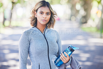Buy stock photo Runner woman, bottle and portrait in park, ready and exercise with fitness training in nature. Indian girl, commitment and pride for wellness, health or outdoor workout for body, self care or goals