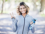 Runner woman, peace sign and portrait in park, smile or outdoor exercise in fitness training in nature. Indian girl, happy and hand for icon, health or workout for body, wellness and success in road
