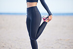 Woman, fitness and stretching legs for exercise, training or outdoor running on the beach. Female person, athlete or runner in preparation, body or feet warm up getting ready for cardio workout