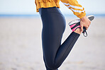 Woman, fitness and stretching legs for workout, training or outdoor running on the beach. Female person, athlete or runner in preparation, body or feet warm up getting ready for cardio exercise