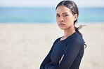 Mockup space, beach and portrait of serious woman by the ocean ready for surf, exercise and workout. Female person, focus and face of a athlete from Hawaii outdoor by the sea in nature with training