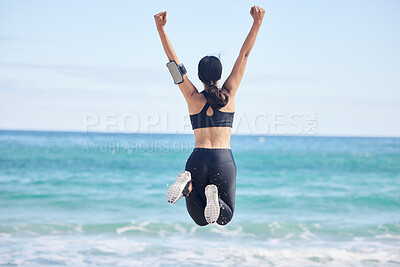 Buy stock photo Happy woman, fitness and jump in achievement on beach for winning, workout success or outdoor exercise. Rear view of excited female person in celebration for accomplishment or training by the ocean