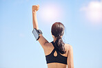 Woman, fitness and fist pump in achievement for winning, workout success or outdoor exercise. Rear view of female person in celebration for accomplishment or training with sky background on mockup