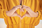 Woman, heart hands and love for care, support or trust in healthcare, romance or gesture. Closeup of female person with emoji, symbol or icon for health, like or wellness in peace, sign or emoticon