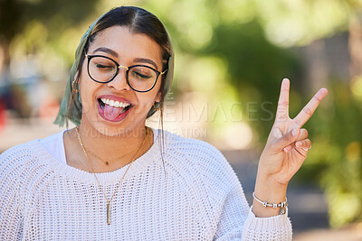 Buy stock photo Peace sign, woman and outdoor with a smile of student on summer holiday and vacation. Motivation, tongue out and emoji v hand gesture feeling silly with freedom and happy young female from Sudan