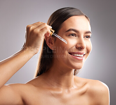 Buy stock photo Beauty, face and woman smile with serum dropper, skincare hydration product or collagen oil treatment for anti aging wellness. Liquid hyaluronic acid, dermatology and studio person on gray background