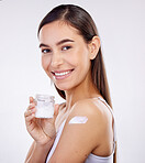 Face, skincare and woman with cream jar isolated on a white background in studio. Portrait, happy and model with sunscreen on shoulder, natural cosmetics or lotion for facial, dermatology and health