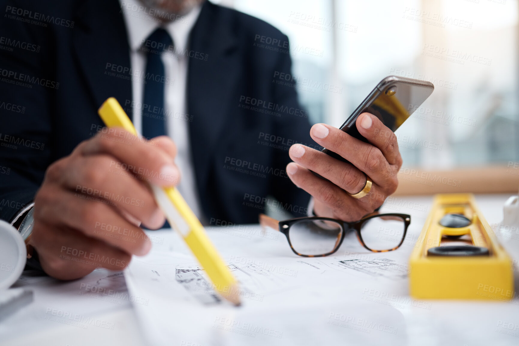 Buy stock photo Phone, hands and pencil of architect man in an office with a blueprint, drawing or floor plan project. Closeup of male engineer with building design, internet connection and sketch for construction