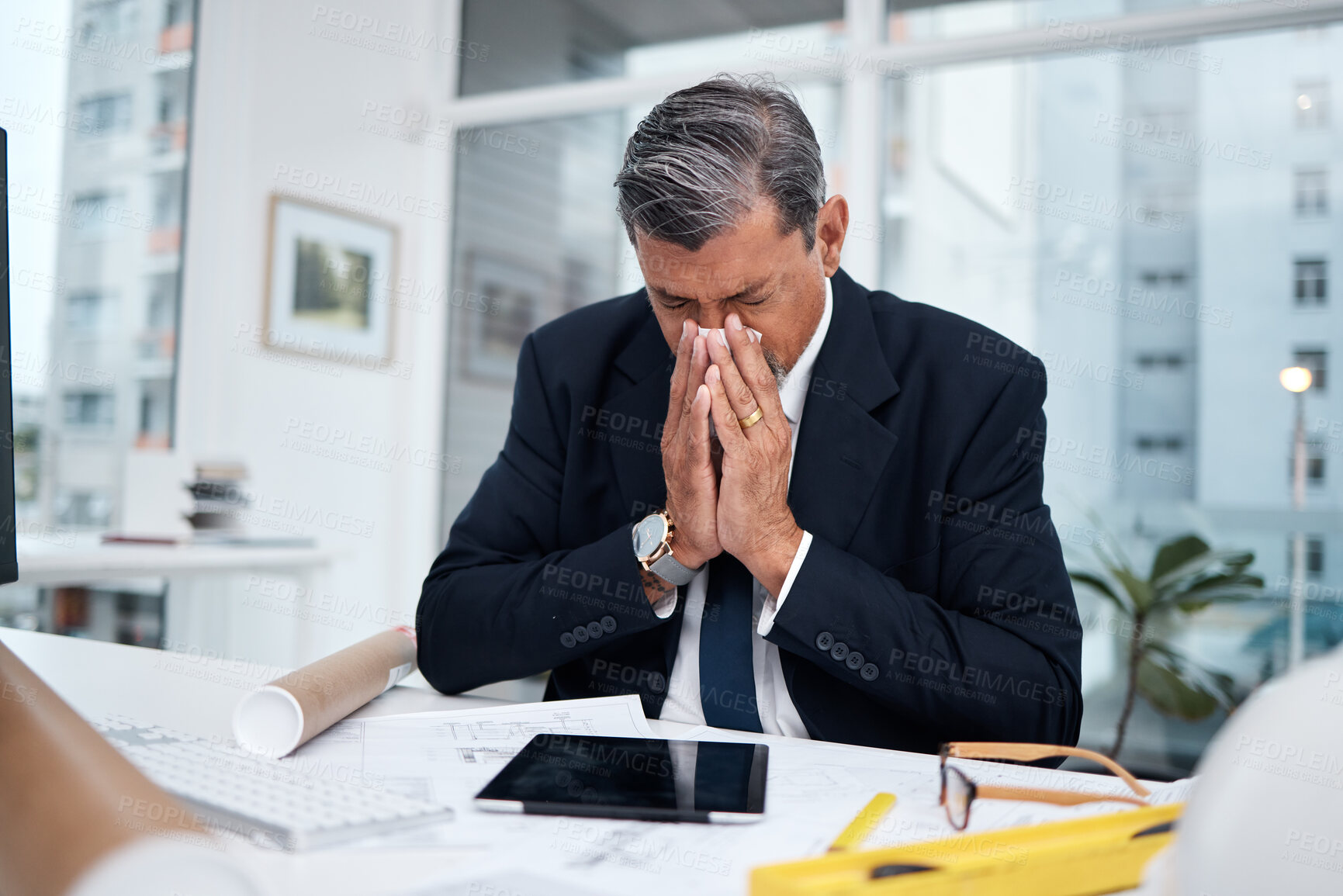 Buy stock photo Sick, professional and architect man in an office with tissue for blowing nose at desk. Mature male engineer person frustrated with flu virus, allergies or health problem in construction industry