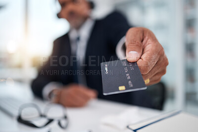 Hand, giving credit card and man in office for payment, ecommerce or budget for shopping in call center. Consultant, crm and banking in closeup for loan, account or bills in telemarketing workplace
