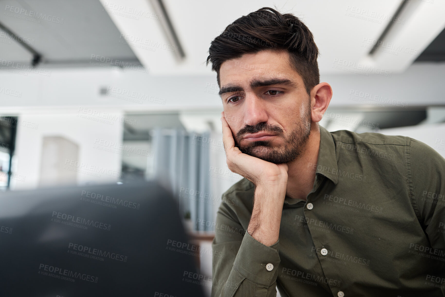 Buy stock photo Sad, businessman and working in an office on laptop, desk and workplace with fatigue, tired energy and burnout. Depressed, consultant and work on computer with anxiety for feedback or project email