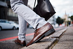 Feet, business man and walking on city road or ground for travel, journey and commute to work. Shoes, legs and closeup of a professional person or employee crossing an urban street with a bag