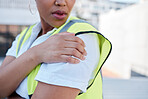 Woman, engineer and hands with shoulder pain outdoor from injury, accident and muscle tension on rooftop. Closeup of female contractor with sore arm, ache and joint inflammation at construction site