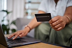 Woman, laptop and hands with credit card in ecommerce, payment or fintech banking on sofa at home. Closeup female person or shopper with debit on computer app in online shopping, purchase or buying