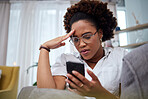 Woman, stress and reading phone in home for notification of bad news, problem and crisis of mistake on social media. Confused african female person with anxiety, doubt and frustrated with mobile scam