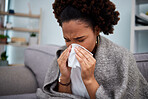 Sick, couch and woman in a blanket with flu at home, house or apartment with a cold, fever and blowing nose. Virus, sad and female person with a tissue ill on sofa in a lounge with a medical problem