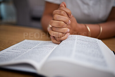 Hands, bible and woman in prayer in home, lounge and reading about Jesus or faith, religion and worship study for mindfulness. Person, praying and studying holy book for peace, praise and meditation