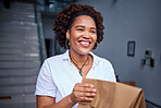 Delivery, happy customer and a woman at a door with a paper bag from courier at home. Face of black person or a client with a package, parcel or fast food from online shopping, e-commerce or service