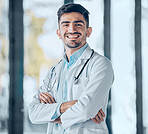 Happy man, doctor and professional with arms crossed for healthcare, advice or career ambition at the hospital. Portrait of male person, surgeon or medical expert smile for healthy wellness at clinic