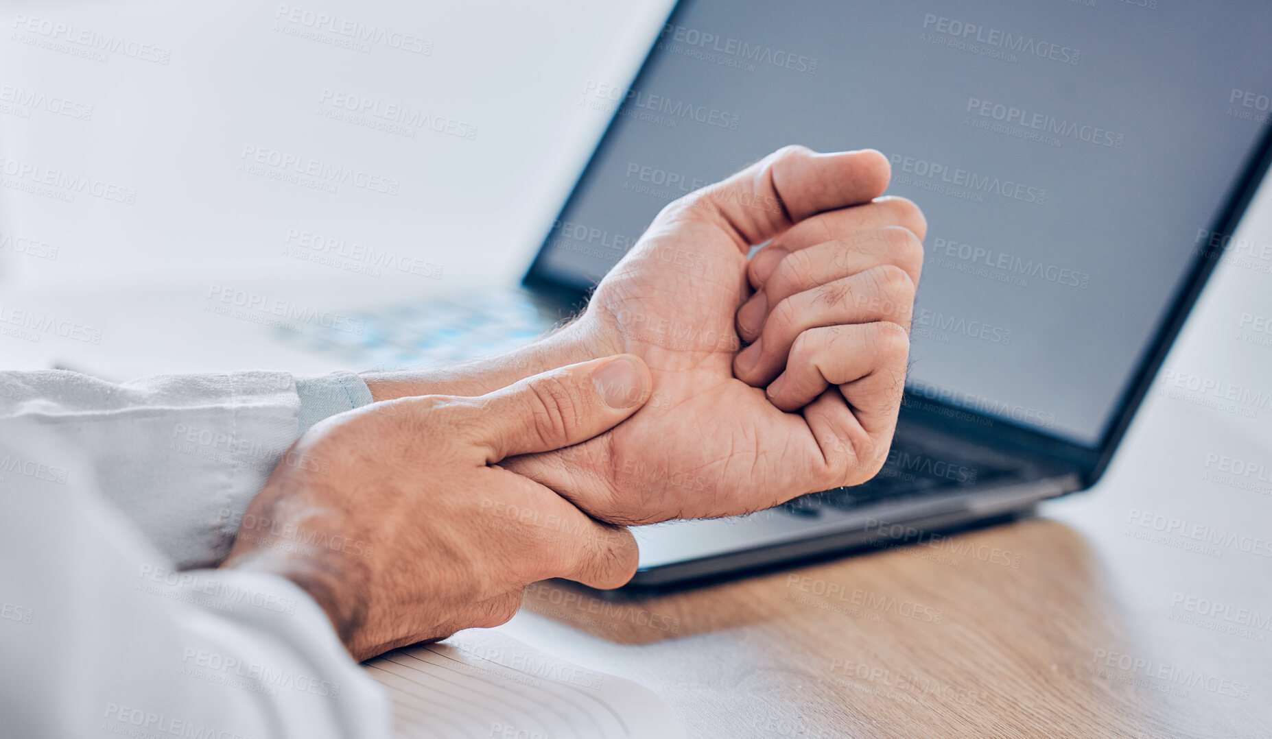 Buy stock photo Man, hands and wrist pain from injury, accident or carpal tunnel syndrome on desk at office. Closeup of male person or employee with bad arm ache, sore muscle or tension and overworked at workplace