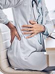 Man, doctor and hands with back pain from injury, accident or posture sitting on chair at the hospital. Closeup of male person, medical or healthcare employee with sore spine, ache or cramp at clinic