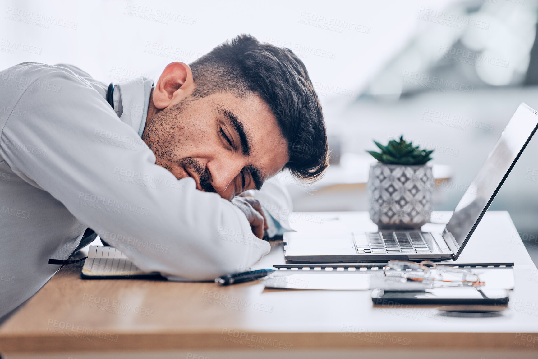 Buy stock photo Man, doctor and sleeping on desk in burnout, overworked or stress from insomnia at the hospital. Exhausted male person, medical or healthcare employee resting or asleep on the office table at clinic