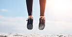 Woman, fitness and shoes in jump on mockup for sports motivation, running or outdoor exercise. Closeup of female person, athlete or runner feet jumping in workout for healthy wellness or training