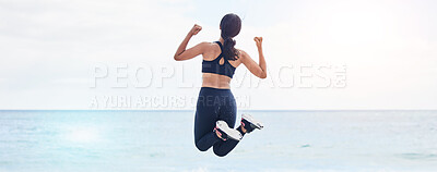 Buy stock photo Back, freedom and fitness woman jump at the beach with celebration after running, training or workout success in nature. Exercise, jumping and behind female at the sea celebrating goal milestone