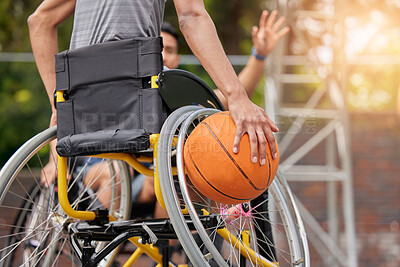 Sports ball, wheelchair basketball and hands of person playing match competition, challenge or attack on outdoor court. Player, commitment and back of athlete with disability, training and exercise