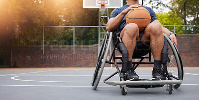 Wheelchair, basketball and man with sports ball at outdoor court for fitness, training and cardio. Exercise, hobby and male with disability at a park for game, workout and weekend fun or active match
