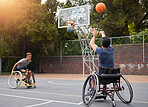 Sports, basketball and men in wheelchair for goal in training, exercise and workout on outdoor court. Fitness, team and male people with disability shoot with ball for competition, practice and games