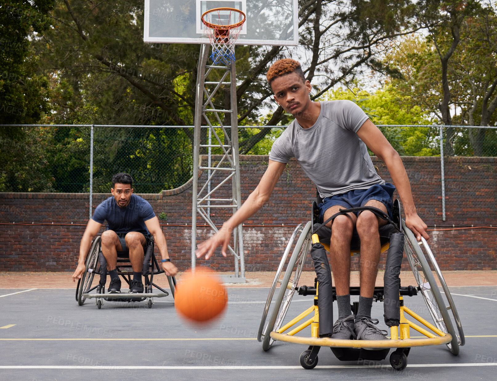 Buy stock photo Sports action, wheelchair basketball or man focus on match competition, outdoor court challenge or fitness. Determined player, dribbling ball or African athlete with disability, training and exercise