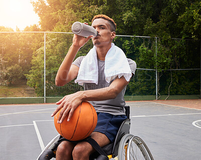 Buy stock photo Basketball player, drinking water or man in wheelchair for sports break, rest or fitness electrolytes on court. Person with a disability, athlete or bottle for recovery, exercise and workout wellness