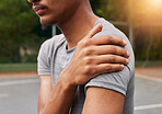 Sports, man and shoulder pain for basketball injury from workout, fitness and exercise in competition. Closeup, athlete and player on court with health problem, accident and first aid for arm wound 