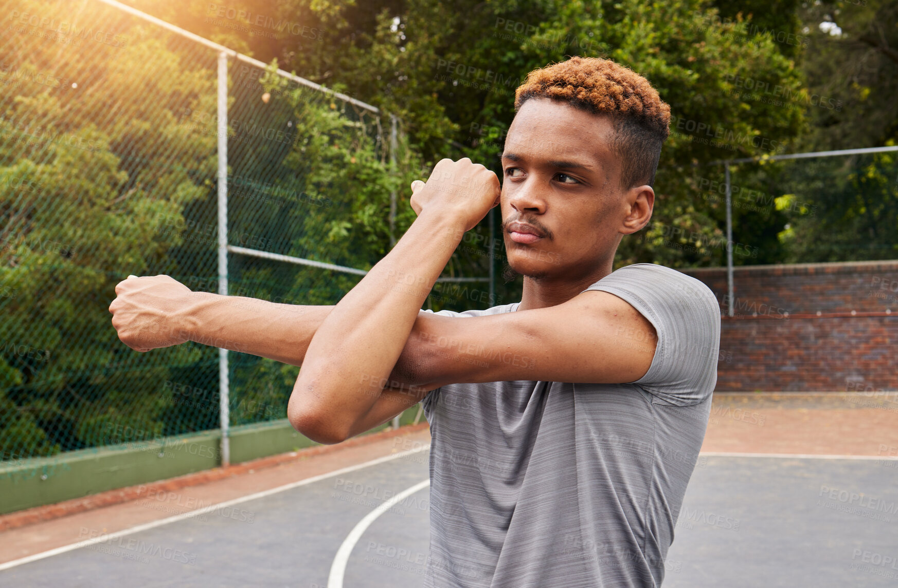 Buy stock photo Man, basketball and stretching arms for sports flexibility, action and mobility. Workout, fitness and strong player with focus on court to prepare for training, exercise and thinking of competition