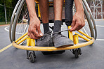 Fitness, wheelchair and man tie shoes ready for training, exercise and workout on outdoor court. Sports, start and male person with disability tying sneakers for performance, wellness and challenge