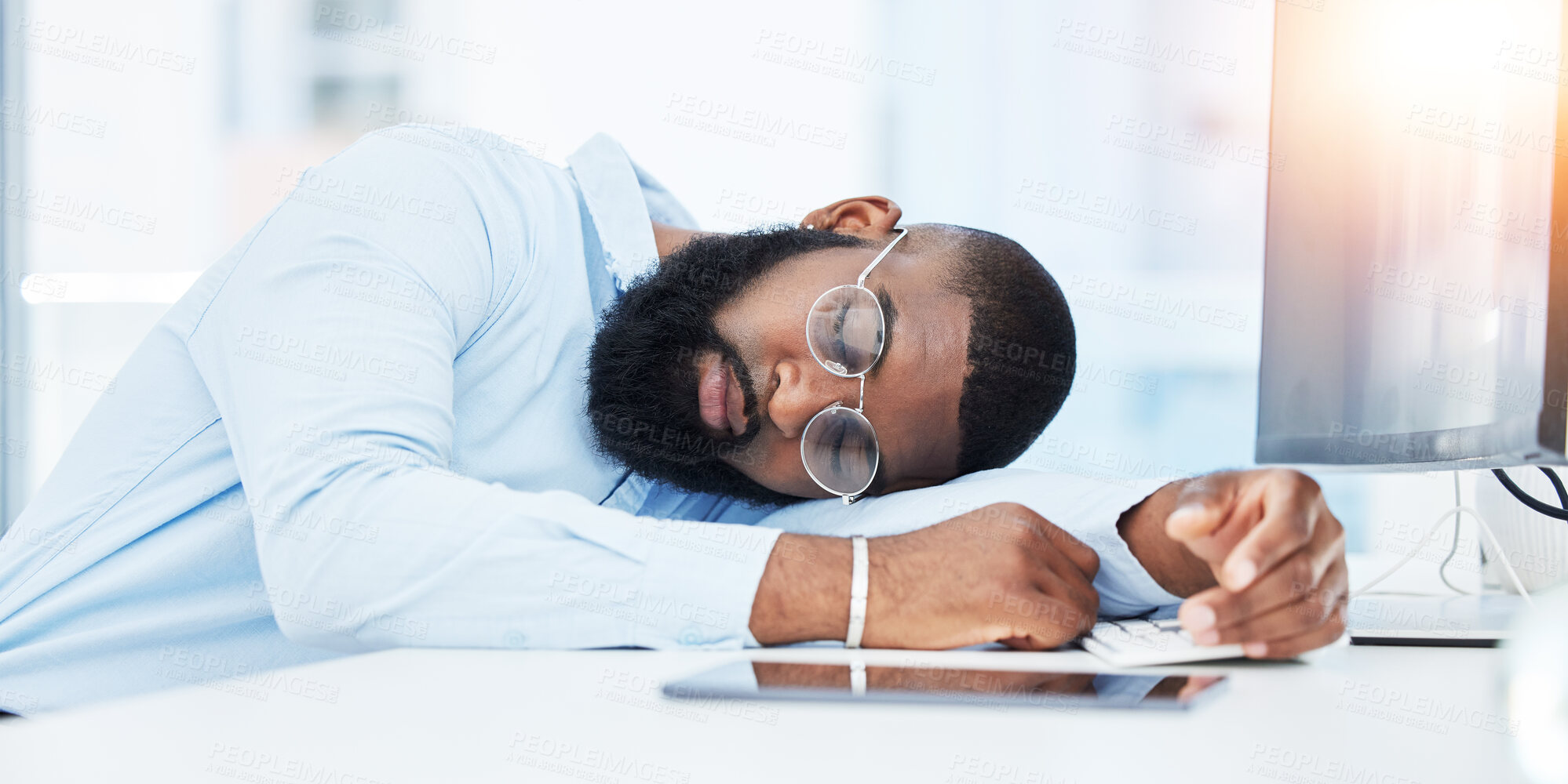 Buy stock photo Sleeping, burnout and tired businessman in office overwhelmed by deadlines with fatigue at desk. Lazy worker, depressed consultant or exhausted black man resting or taking nap in overtime with stress