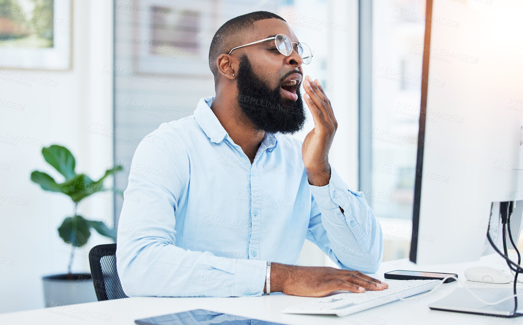 Buy stock photo Yawn, tired employee and black man at desk, burnout and agent with startup company, feeling exhausted and computer. Fatigue, early morning and consultant working on pc with overtime, tech and sleepy